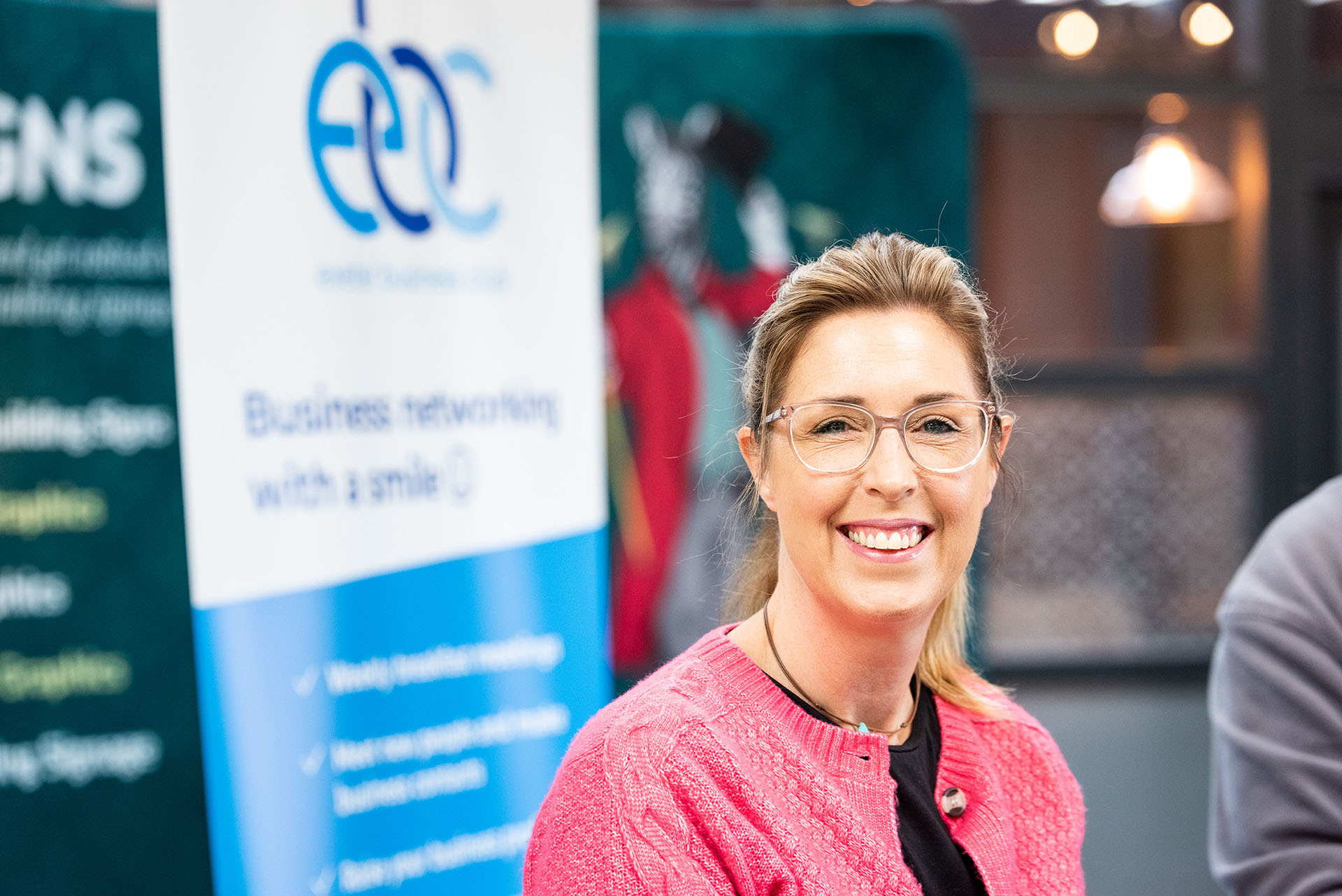 A smiling member at a Friday breakfast